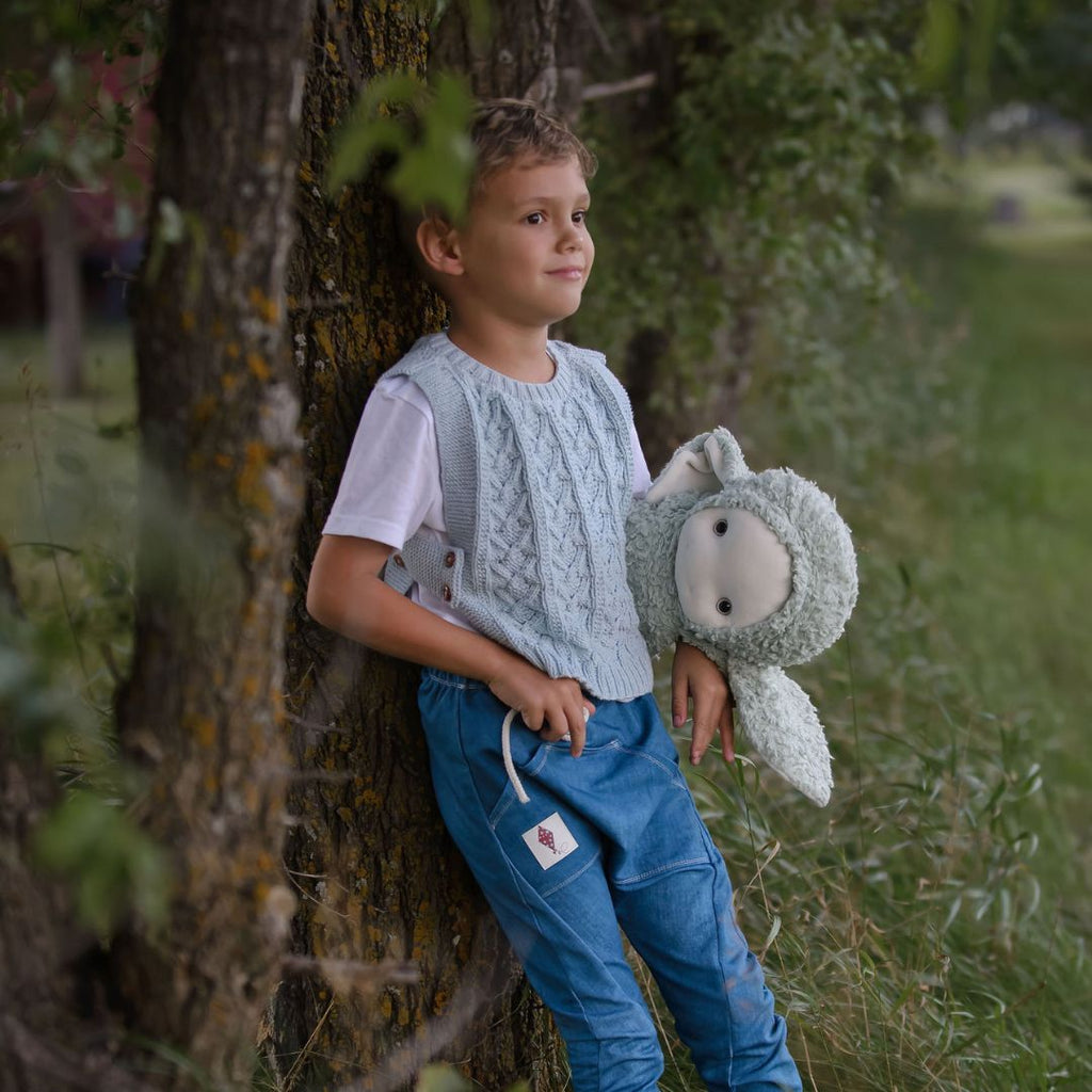 Aspen Cropped Vest — gender-neutral hand-knit cable knit vest in cotton bamboo with adjustable side ties and wooden buttons for baby & kids by JuneBee Baby.