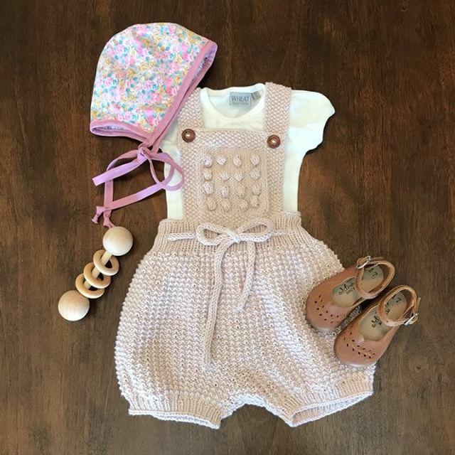 Artisan hand-knitting the Athens Romper, a gender-neutral baby romper in natural cotton bamboo yarn