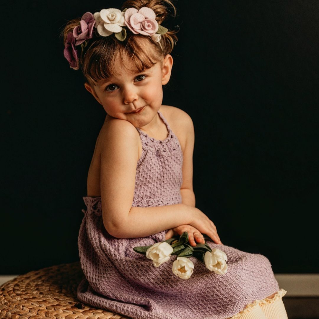 Hand-knit T-back dress for girls in cotton bamboo — flowy crochet back design, adjustable neckline, available in baby, kids, and doll sizes by JuneBee Baby.