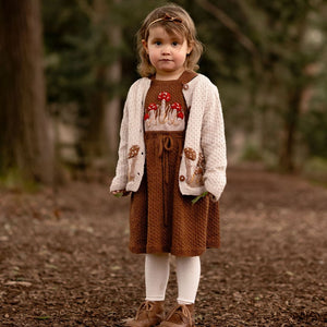 Hand knitted children's clothing with mushroom motifs