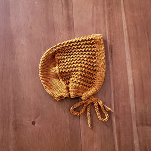 Hand knit lace baby bonnet in cinnamon