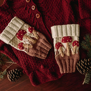 Flat lay of hand-knit mushroom leg warmers in creamy green cotton bamboo, mushroom baby stuff for kids by JuneBee Baby.
