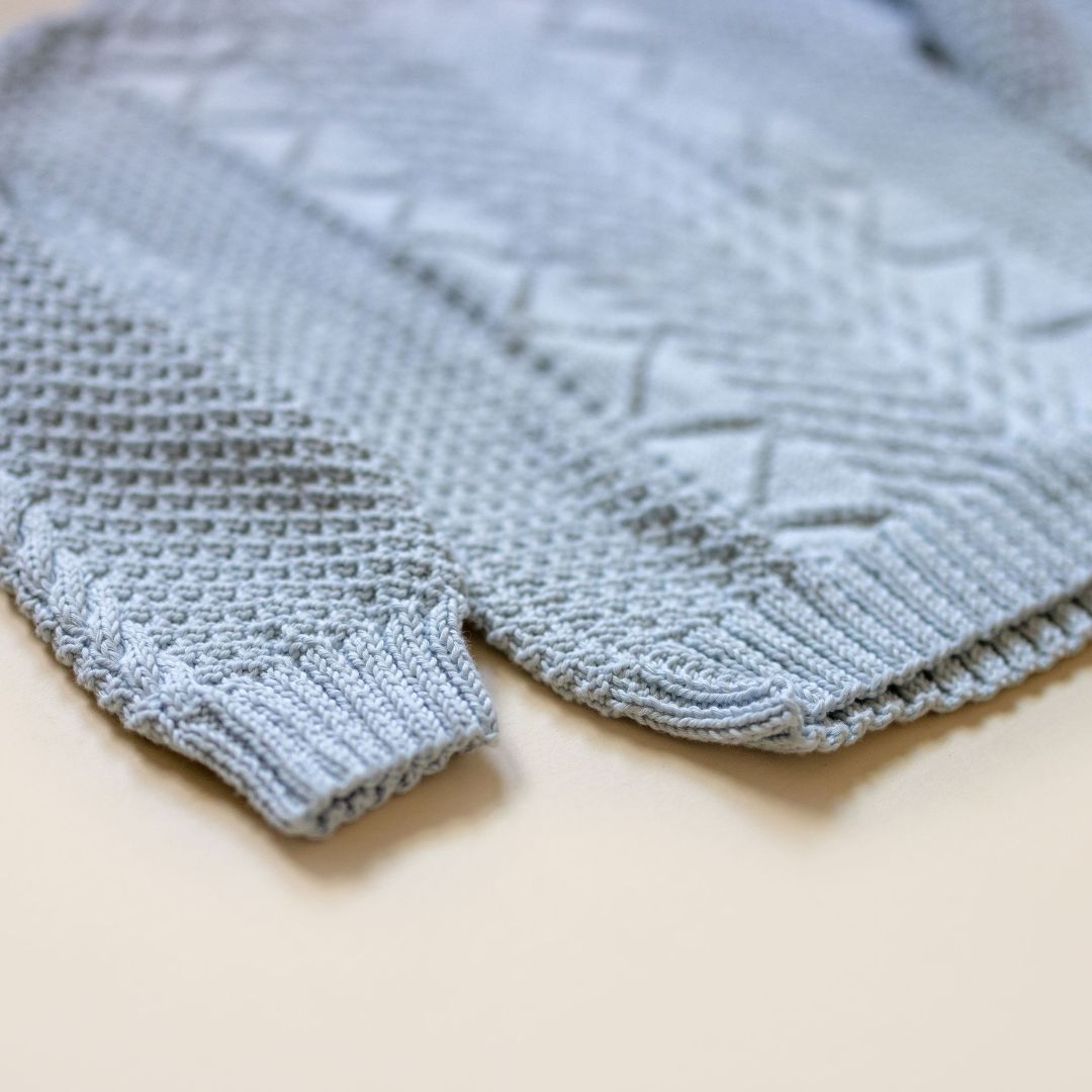 Close-up of Troy Pullover texture, hand-knit Aran-inspired knitwear by JuneBee Baby