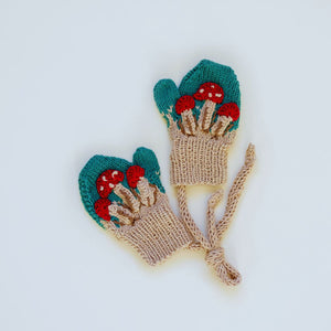 Flat lay of hand-knit mushroom mittens in hunter green cotton bamboo, heirloom quality kids mushroom accessories by JuneBee Baby.