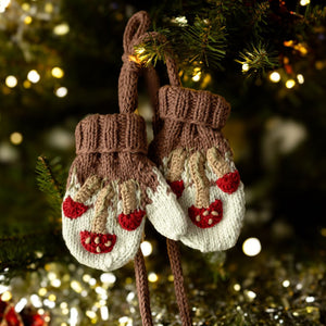 Close-up picture of hand-knit mushroom mittens in creamy green cotton bamboo showing whimsical mushroom motif detail.