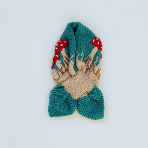 Flat lay of hand-knit mushroom neck scarf in hunter green cotton bamboo, eco-friendly artisan-made kids scarf.