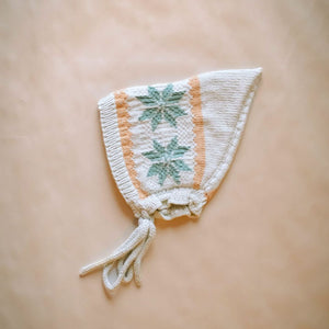 Picture of a hand-knit snowflake motif on creamy green Nordic pixie hat in cotton bamboo.